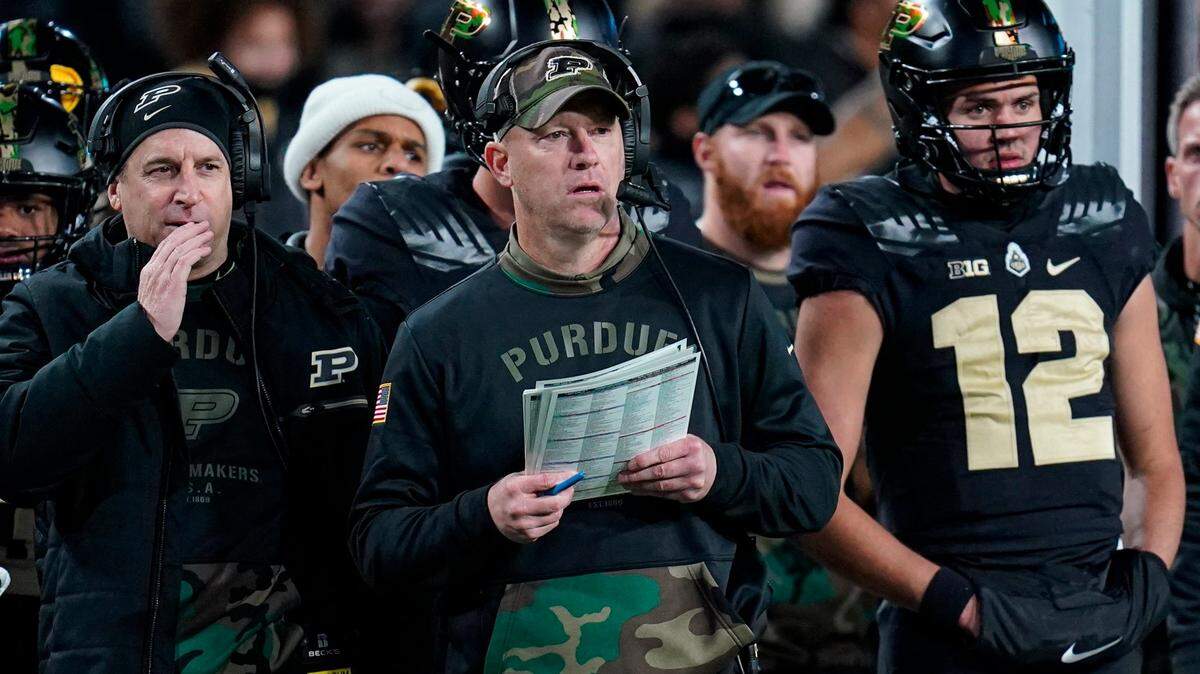 Purdue head coach Jeff Brohm, center, watches from the sideline during the second half of an NCAA college football game against Michigan State in West Lafayette, Ind., Saturday, Nov. 6, 2021.