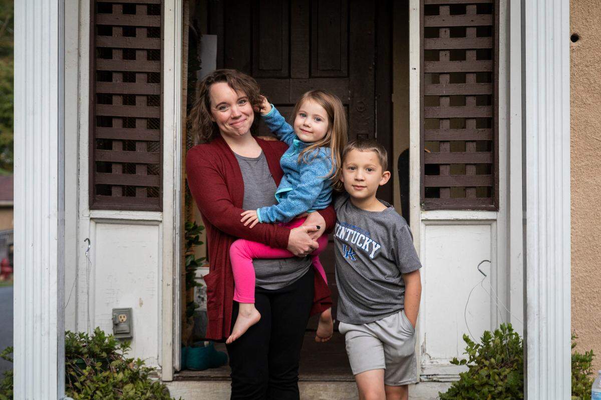 Stephanie Naillieux, an ICU nurse in Pikeville, poses for a portrait with her children Lily, 4, and Aaron, 11, outside their home in Lynch, Ky., Tuesday, September 22, 2020. Nailliuex has had bears come right up to her while she was reading on her front porch. Bears have also flipped their chicken coop and ripped the cover off of her truck to get at some trash. Naillieux says that the bears are just part of living in this part of the state and she just tries to be cautious around them.