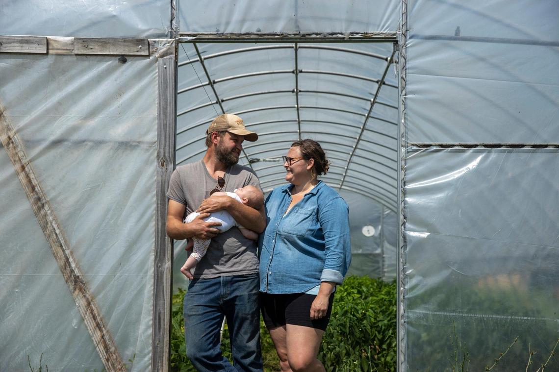 Joseph and Abbie Monroe with their 3-month-old daughter, Opal, at Valley Spirit Farm in Henry County, where they produce organic vegetables, gourmet mushrooms, grass-fed beef and pastured pork for the Louisville market. The Monroes and others are fighting plans by Angel’s Envy to turn the cattle farm next door into a 25-warehouse bourbon tourism campus.