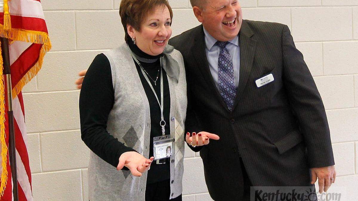 Jessamine Co. Schools Superintendent  Lu Young, left was hugged by Wayne Young, Executive Director of Kentucky Association of School Administrators, right,  as she was awarded the 2012 superintendent of the year award in a surprise ceremony at Jessamine Career and Technology Center, in Nicholasville, Ky., on Nov. 30, 2011.  Photo by Pablo Alcala | Staff 