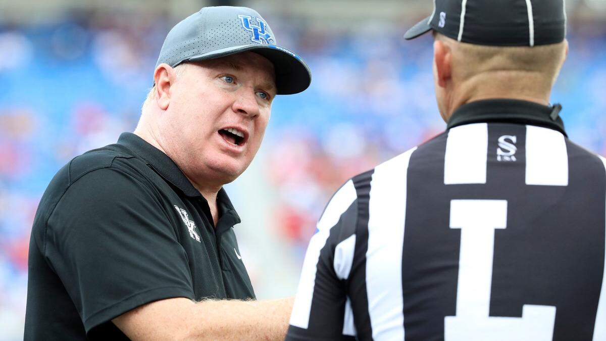 Kentucky head coach Mark Stoops speaks with an official during Saturday’s game against Ball State.