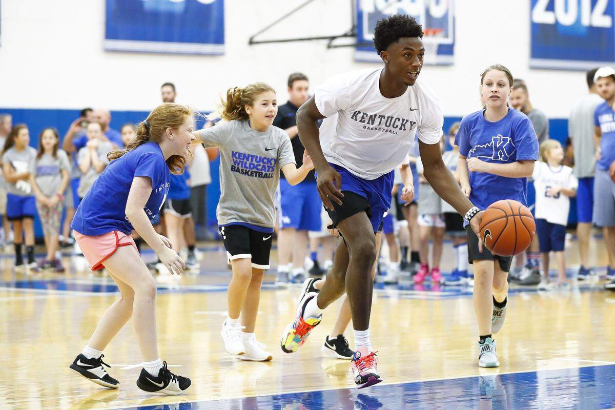 Kentucky guard Ashton Hagans dribbles between Claire Tabeling, 11, of Marietta, Ga., from left, Laney Perkins, 11, of Louisville, Ky., and Alissa Perkins, 11, Owensboro, Ky., during The inaugural John Calipari Father/Daughter Camp at the Joe Craft Center in Lexington, Ky., Saturday, June 22, 2019.