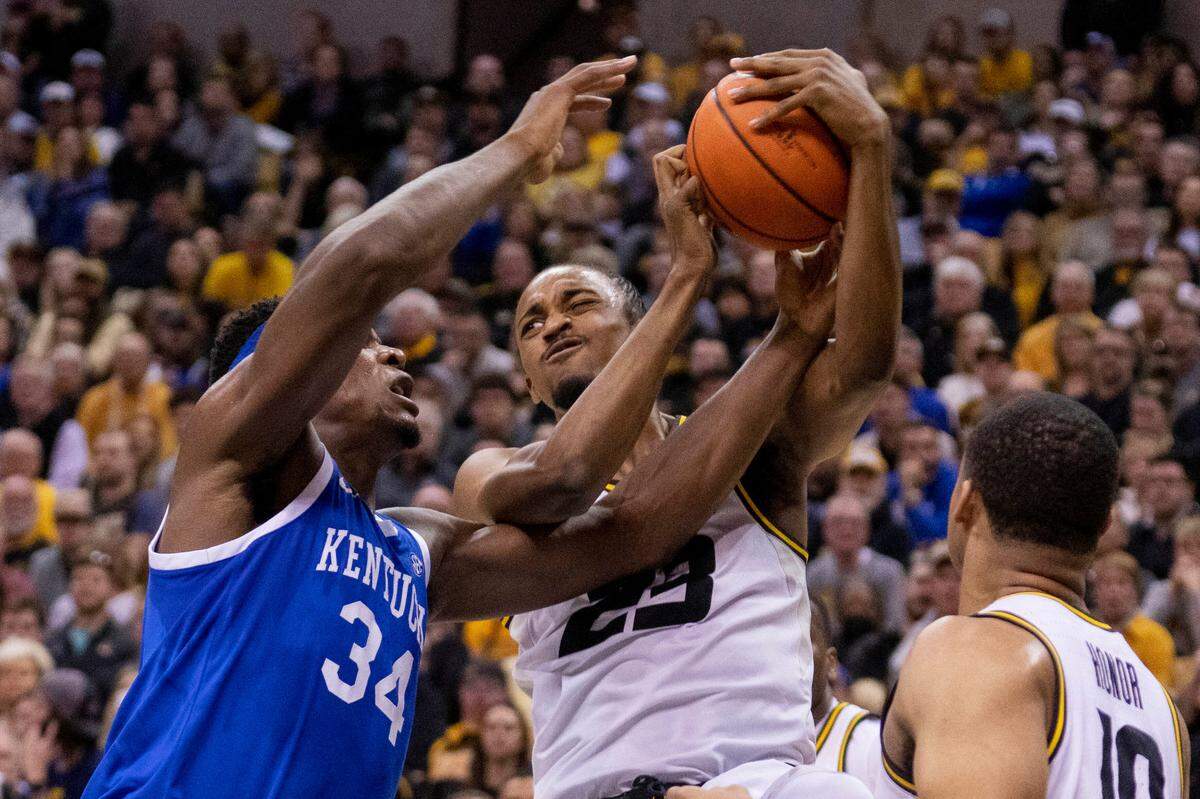 Missouri’s Aidan Shaw, right, and Kentucky’s Oscar Tshiebwe, left, fight for a rebound during the first half of an NCAA college basketball game Wednesday, Dec. 28, 2022, in Columbia, Mo. (AP Photo/L.G. Patterson)
