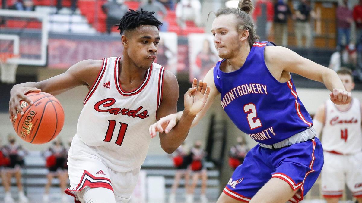 Clark County’s Jerone Morton (11) dribbled against Montgomery County’s Brandon Dyer (2) during their game in Winchester on Jan. 8. Morton hit the game-winner at the buzzer Saturday in the 10th Region title game.