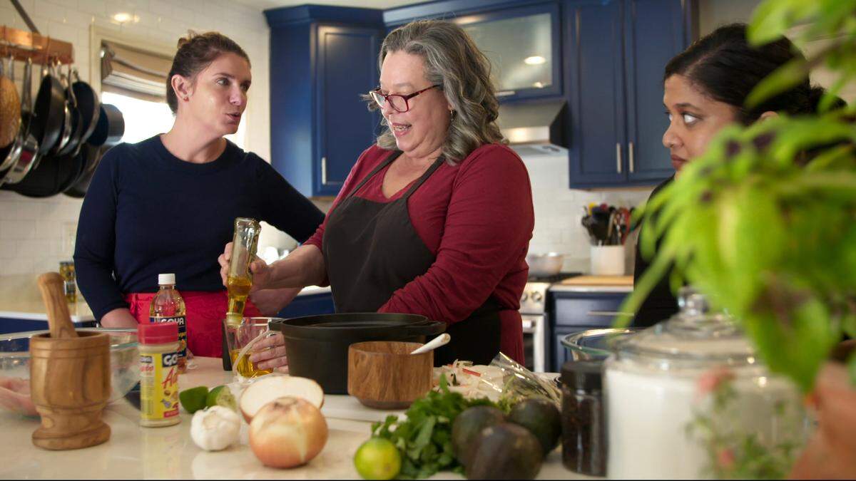 Chef Vivian Howard learns how to make catfish escabeche from chef Agnes Marrero as chef Samantha Fore looks on in her home kitchen in Lexington.
