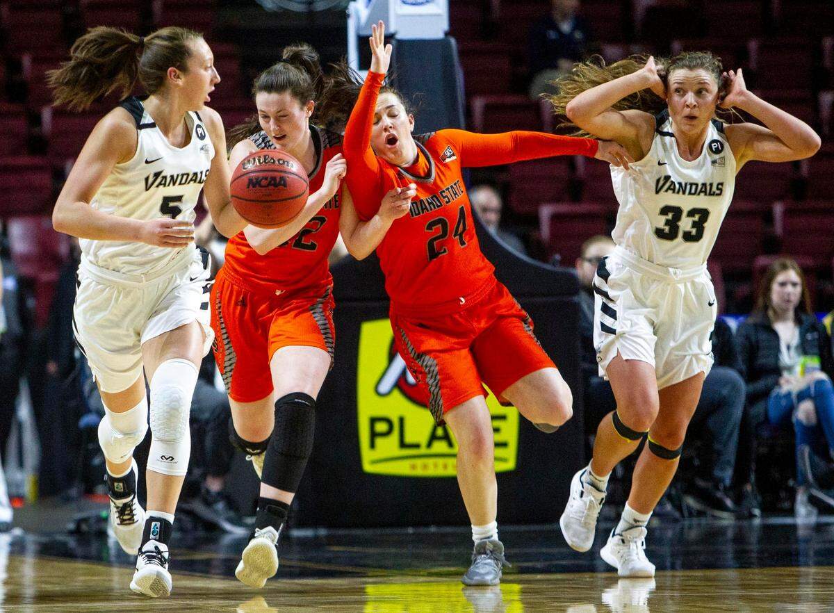 Idaho State’s Delaney Moore (left in orange) hit eight of 10 shots and scored 16 points in the Bengals’ 84-49 route of archrival Idaho in the Big Sky Conference Tournament championship game.
