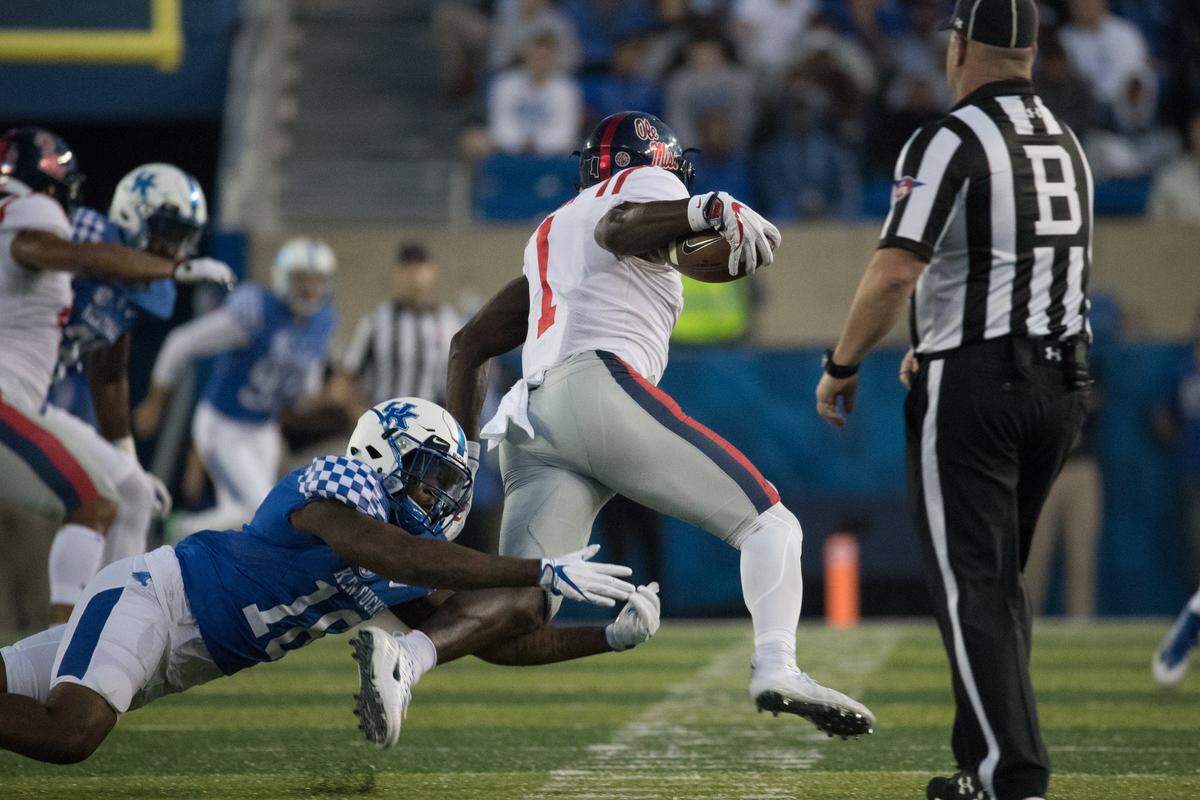 Marcus Walker tried to make a tackle during Kentucky's game against Ole Miss at Kroger Field last season.