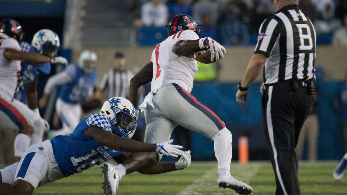 Marcus Walker tried to make a tackle during Kentucky's game against Ole Miss at Kroger Field last season.