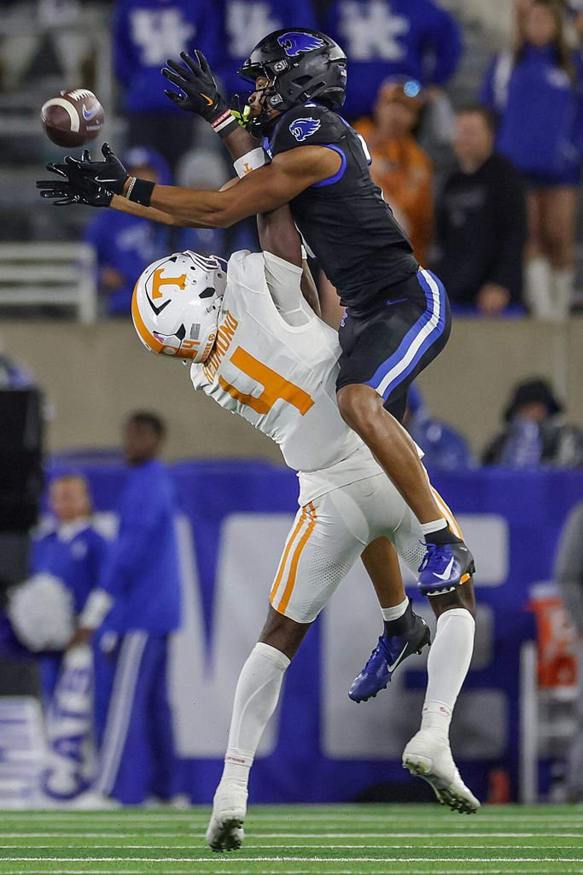 LEXINGTON, KENTUCKY - OCTOBER 25: DJ Miller #7 of the Kentucky Wildcats reaches for the ball as Ty Redmond #4 of the Tennessee Volunteers defends during the second half of the NCAA football game Kentucky Wildcats vs Tennessee Volunteers at Kroger Field on October 25, 2025 in Lexington, Kentucky. (Photo by Michael Hickey/Getty Images)