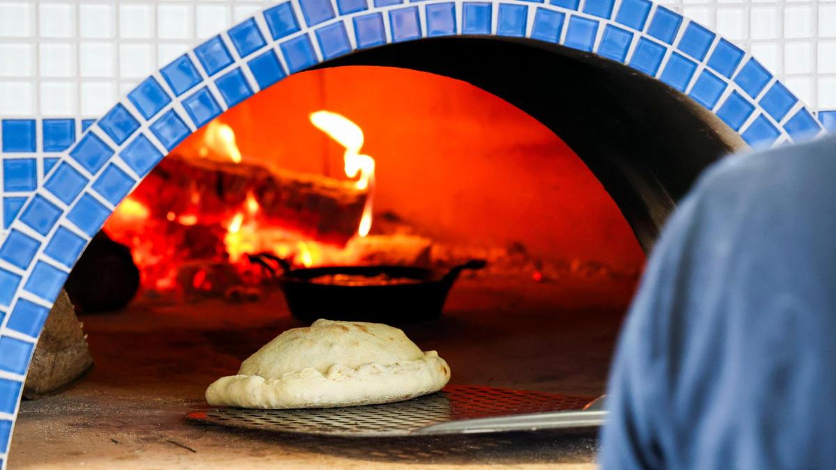 A calzone goes into the wood-fired oven at Black-Type Brewing. All pizza’s on the menu can be made into a calzone at the new Lexington taproom and restaurant. The dough and sauce for all are homemade, made on site.