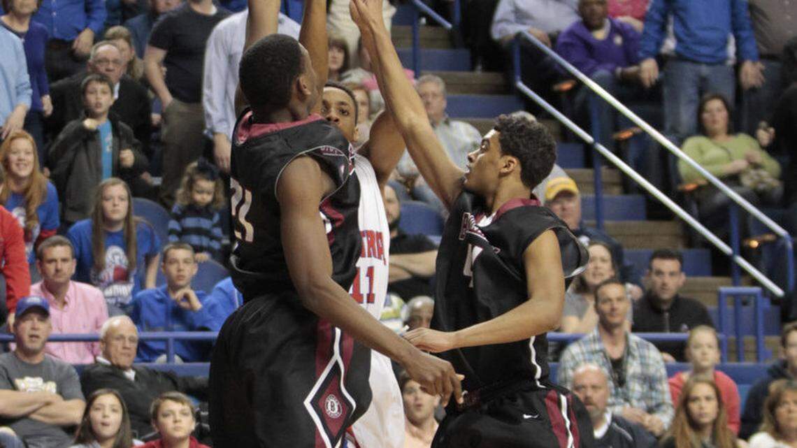 Madison Central's Ken-Jah Bosley hit the winning three-point basket over Ballard's Jalen Perry, left, and Ballard's Quentin Snider in the Sweet Sixteen boy's basketball championship game on Sunday.  Madison Central won, 65-64.   Photo by Pablo Alcala | Staff
