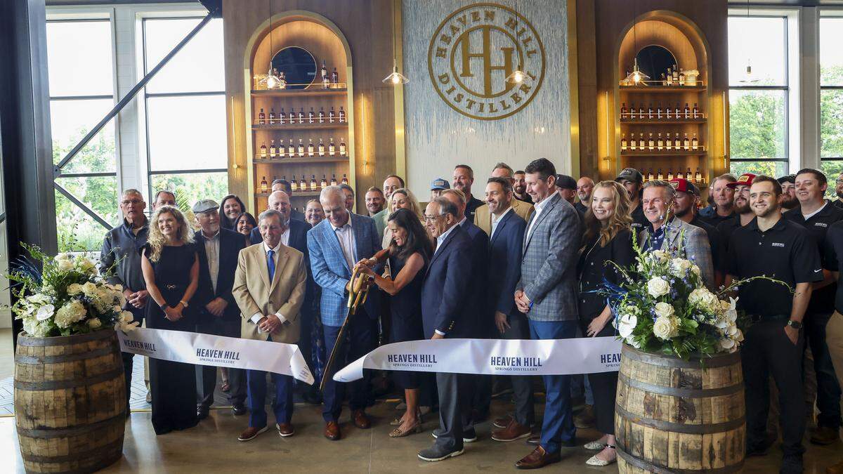 Employees and Kate Latts, president of Heaven Hill (holding sciscors) cut the ribbon at the opening of the Kentucky bourbon maker’s new $200 million distillery, Thursday, Sept. 4, 2025 in Bardstown, Ky. The new distillery will open in three stages and is designed to expand in 150,000-barrel increments until it reaches a 450,000-barrel capacity, doubling Heaven Hill’s output.