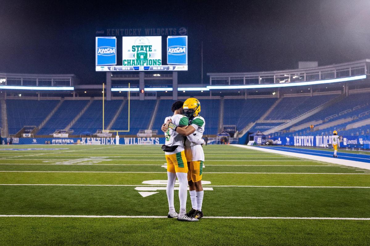 Bryan Station senior JT Haskins Jr., left, hugged his younger brother, freshman Jordan Haskins, following the Defenders’ loss to Trinity in the KHSAA Class 6A state football championship at Kroger Field on Saturday.