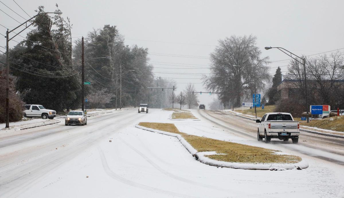 Traffic moves down Tates Creek Road near the Lansdowne neighborhood in Lexington, Ky. Friday morning, Feb. 4, 2022 after an overnight winter storm of ice, sleet and snow blanketed the city.