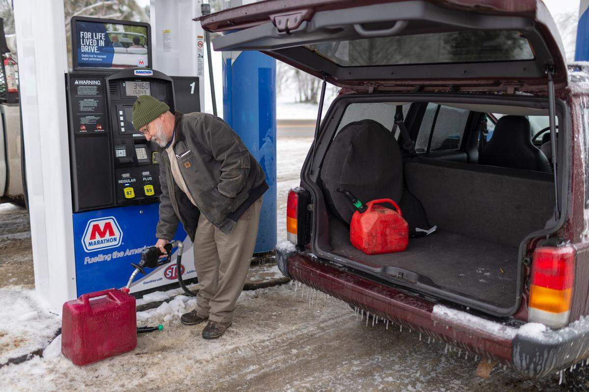 Jerry Sparks fills up gas cans for his Jeep and generator for his home in New Zion at the Gray Hawk Landing in Jackson County, Ky., Wednesday, February 17, 2020. The National Weather Service has forecasted another winter storm to drop more snow Wednesday night and Thursday.