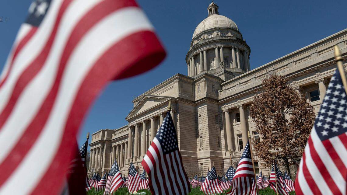 The Capitol is seen through flags placed in the lawn in Frankfort, Ky., Monday, March 29, 2021. The flags honor the more than 6,000 Kentuckians who have died from COVID-19.