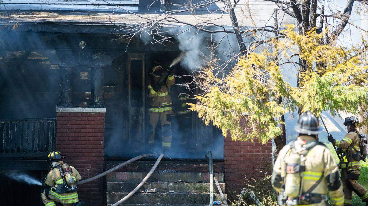 Firefighters work on a house fire on the corner of Limestone Street and Paris Avenue in Lexington, Ky., Friday, August 12, 2022.