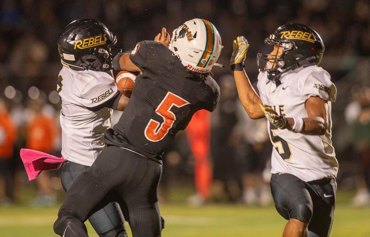 Boyle County’s Sage Dawson, left, and Montavin Quisenberry broke up a pass to Frederick Douglass wide receiver Aveion Chenualt (5) during the Rebels’ 28-7 win last season. Douglass travels to Boyle County on Friday to renew their rivalry.
