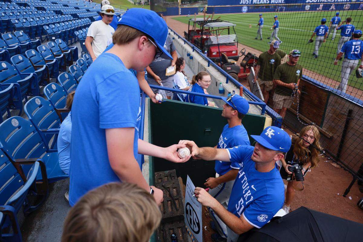 Kentucky pitcher Trey Pooser (51) signs an autograph for a fan before the Wildcats played South Carolina in the SEC Tournament at Hoover, Alabama, last month.