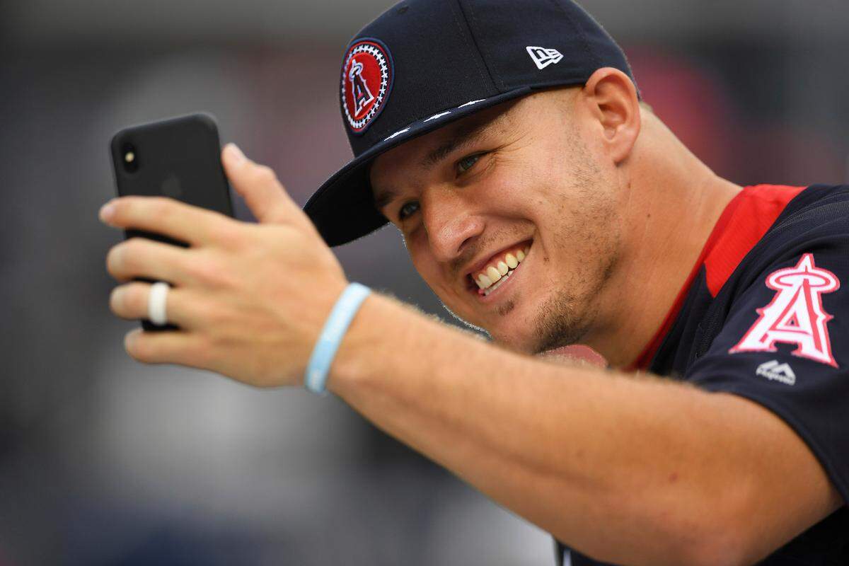 Los Angeles Angels outfielder Mike Trout takes a photo on the field ahead of the All-Star Home Run Derby Monday at Nationals Park, in Washington. The 89th MLB baseball All-Star Game will be played Tuesday.
