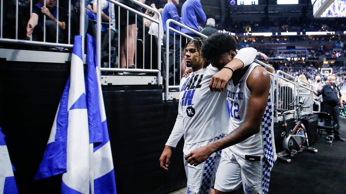 Kentucky players Bryce Hopkins, left, and Keion Brooks left the court after the Cats’ loss to Saint Peter’s in the first round of the 2022 NCAA Tournament. After the season, Hopkins transferred to Providence, and Brooks left UK for Washington.