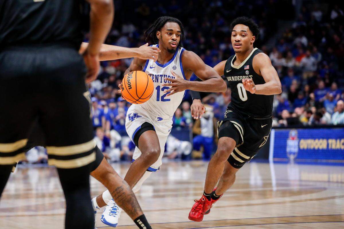 Kentucky Wildcats guard Antonio Reeves (12) dribbles the ball around Vanderbilt Commodores guard Tyrin Lawrence (0) during the SEC Tournament quarterfinal’s game at Bridgestone Arena in Nashville, Tn., Friday, March 10, 2023. Lawrence has entered his name into the NCAA transfer portal.