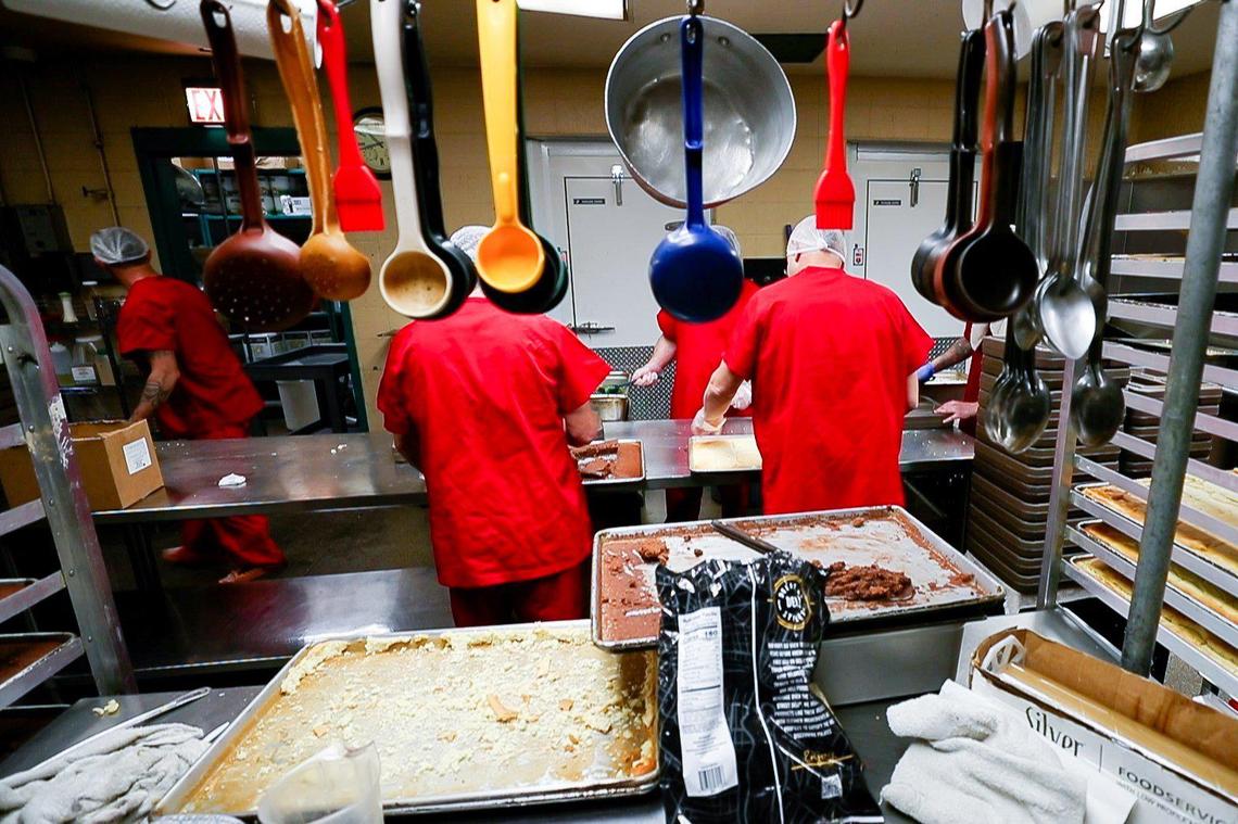 Inmates prepare meals in the kitchen on Thursday, June 30, 2022, at the Madison County Detention Center in Richmond, Kentucky.