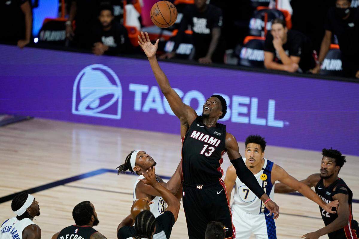 Miami Heat’s Bam Adebayo (13) grabs the ball over the Indiana Pacers during the second half of an NBA basketball first round playoff game Monday, Aug. 24, 2020, in Lake Buena Vista, Fla.