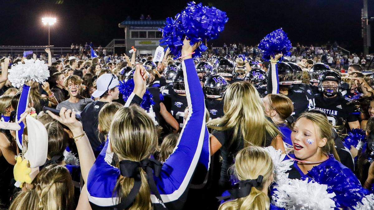 Lexington Christian students storm the field after LCA's 28-21 win over Lexington Catholic during a high school football game, Friday, Sept. 19, 2025 at Lexington Christian Academy in Lexington, Ky.