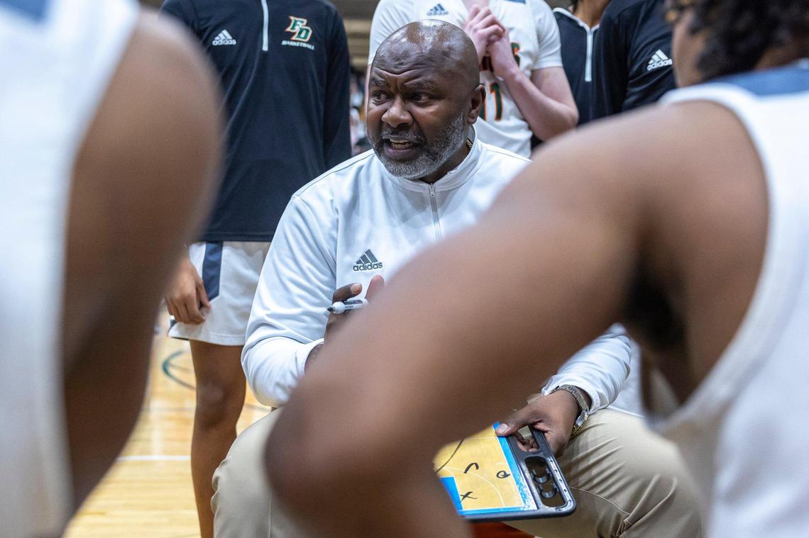 Frederick Douglass head coach Murray Garvin talks to his players during a timeout of their game against Bryan Station at Frederick Douglass High School on Jan. 15.