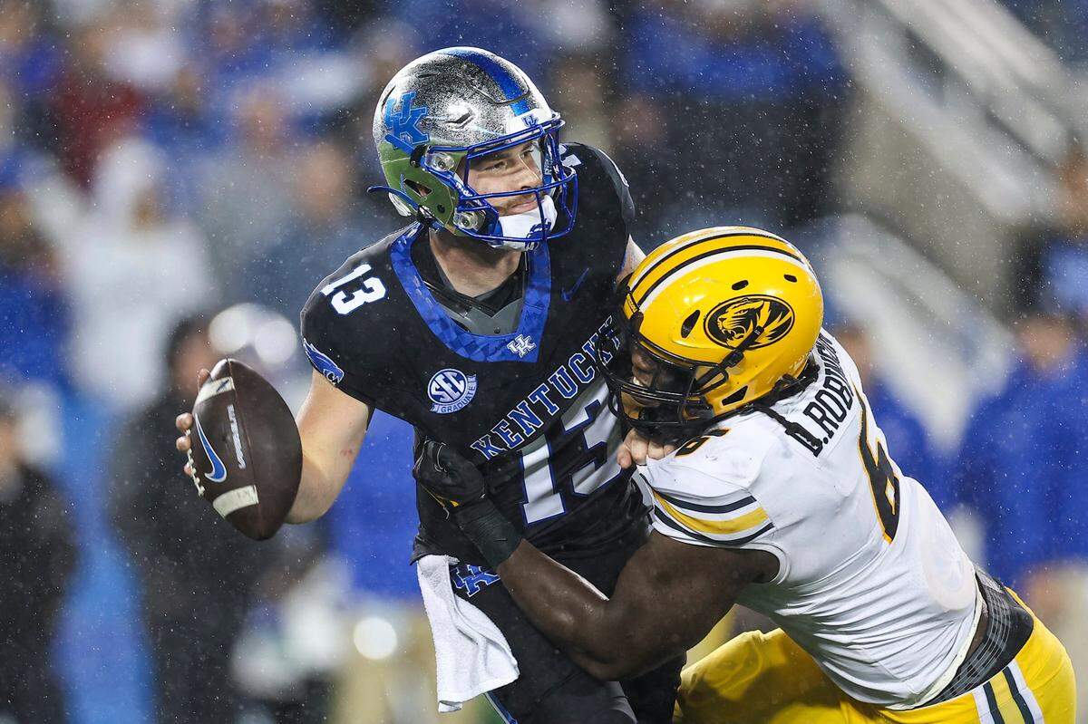Kentucky quarterback Devin Leary (13) is sacked by Missouri defensive lineman Darius Robinson (6) in the second half.