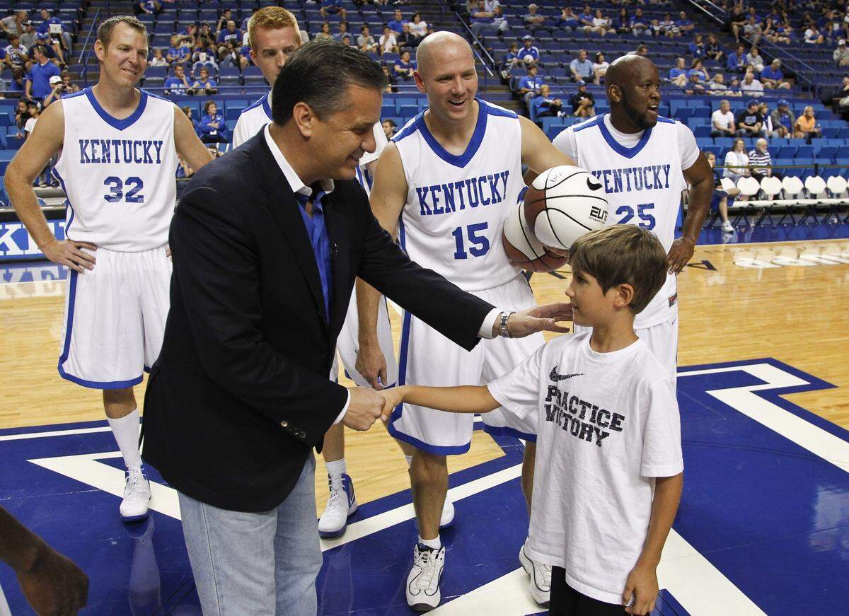 UK Coach John Calipari met an 8-year-old Reed Sheppard as former Kentucky basketball star Jeff Sheppard (15) looked on as former Wildcats players gathered for a charity alumni game on Sept. 15, 2012, at Rupp Arena in Lexington.