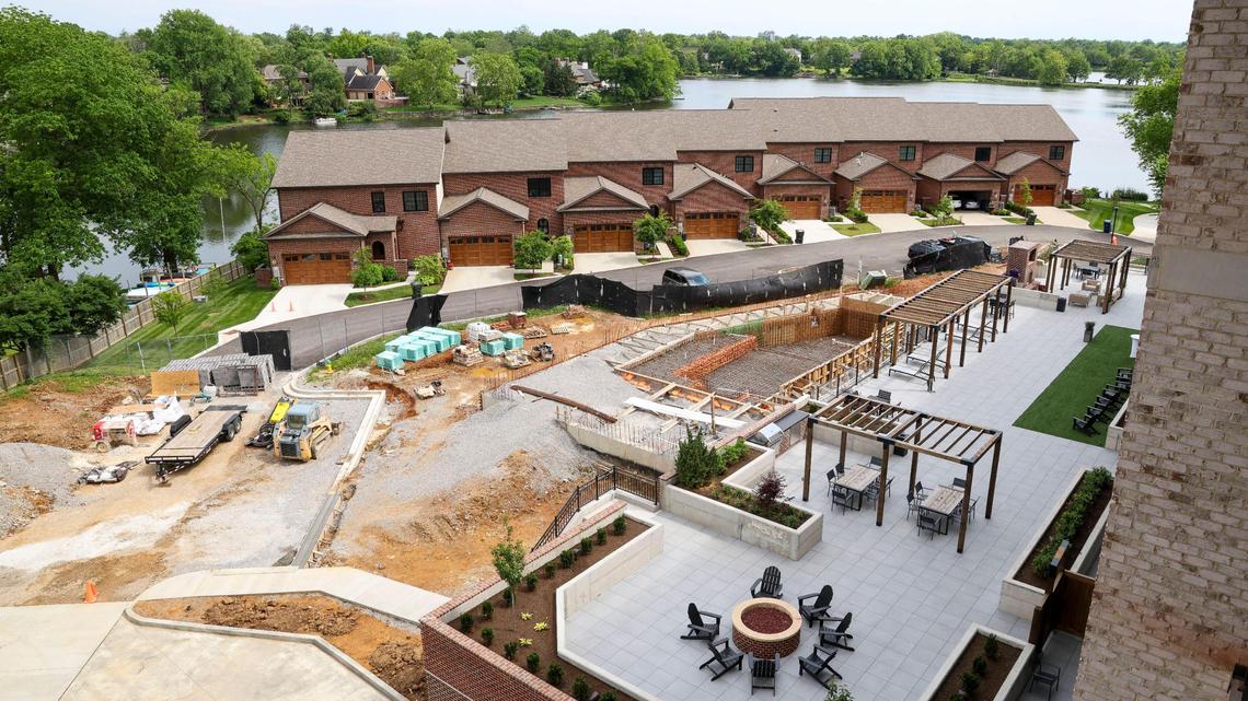 A fire pit and outdoor seating area overlook a pool, under construction, at The Landing at Lakewood Harbour, shown Thursday, May 29, 2025 in Lexington, Ky. The five-story high-end apartment development overlooks Lake Fontaine and includes townhomes along the banks of the lake.