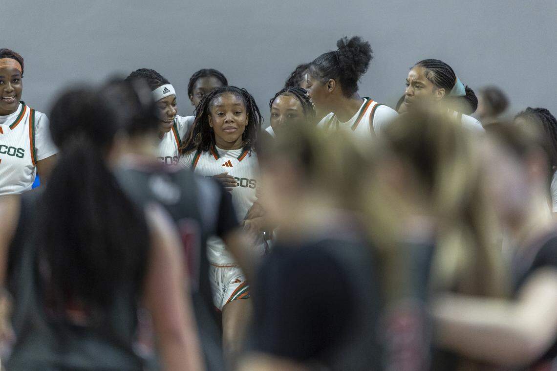 Frederick Douglass' Eiona Atkins (3) is surrounded by her teammates following a victory against Paul Laurence Dunbar during the Girls 11th Region Tournament championship game at Eastern Kentucky University's Baptist Health Arena in Richmond, Ky., on Sunday, March 8, 2026.