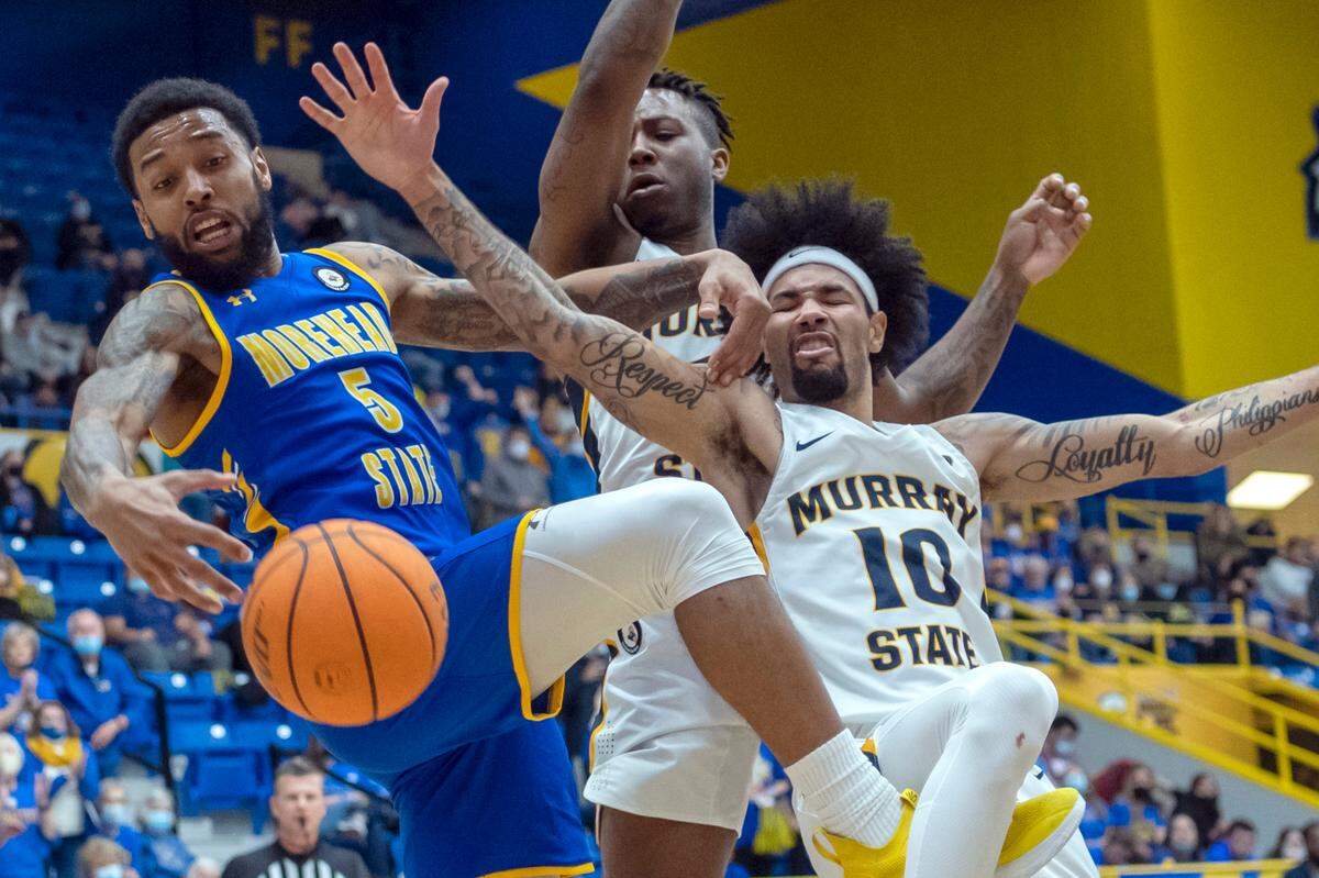 Morehead State’s Skyelar Potter (5) tries to control a rebound against Murray State’s Carter Collins, center, and Tevin Brown (10) during the second half Saturday in Morehead.