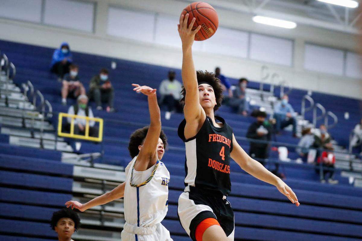 Frederick Douglass’ Kai Simpson (4) shoots over Henry Clay’s Sincere Madison (4) on March 9, 2021.
