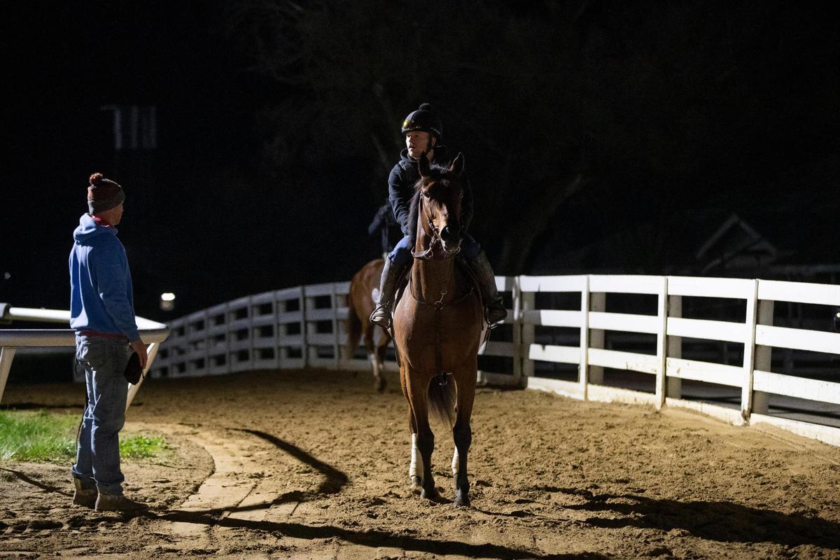 Will Walden and Tyler Maxwell talk after taking one of Ready Made Racing’s horses to breeze in the early morning at Keeneland in Lexington, Ky., Saturday, April 2, 2022.