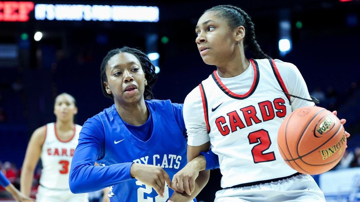 George Rogers Clark’s Teigh Yeast (2) drives against Franklin-Simpson’s Vanessa Ray (23). Yeast delivered eight points and four rebounds for the Cardinals.