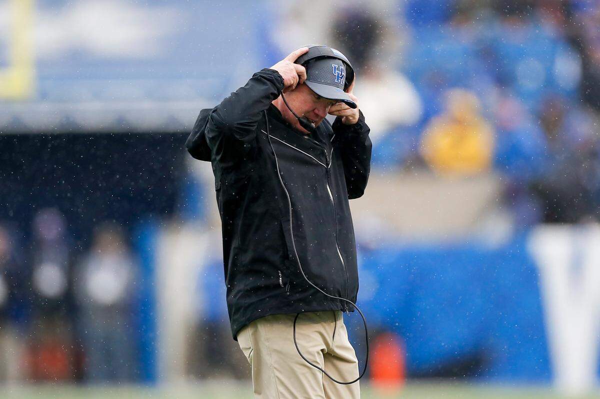 Kentucky head coach Mark Stoops walks off the field after a timeout during Saturday’s game against Vanderbilt.