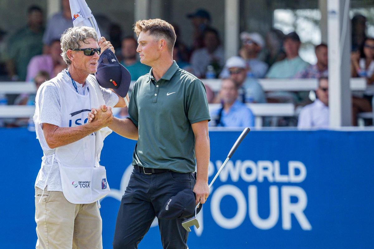 William Mouw, center, shakes hands with a caddie after finishing on the 18th hole during the final round of the ISCO Championship on Sunday, July 13, 2025, at Hurstbourne Country Club in Louisville, Ky.