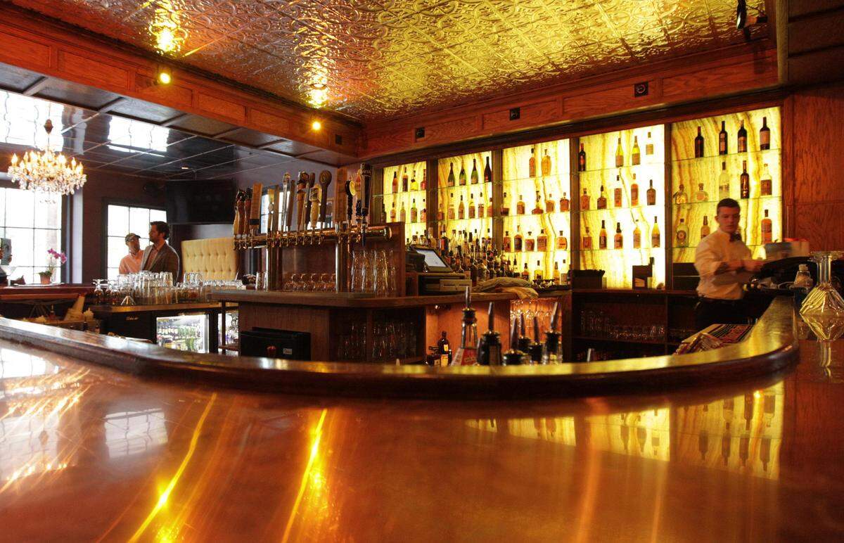 Backlighting showcases the bourbon at Belle’s Cocktail Place. The establishment received the Clyde Carpenter Adaptive Reuse Award for historic preservation.