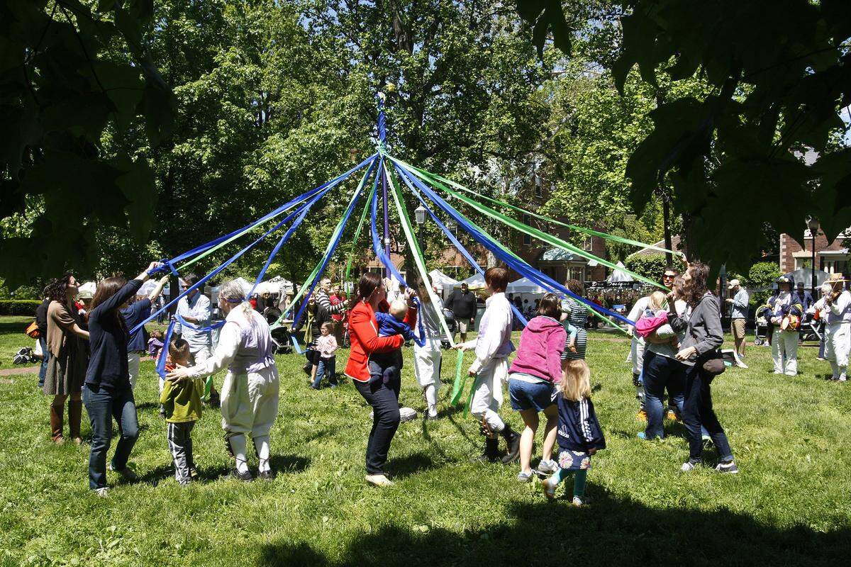 People dance around the maypole during Mayfest at Gratz Park in 2013. This year's event is Saturday and Sunday.