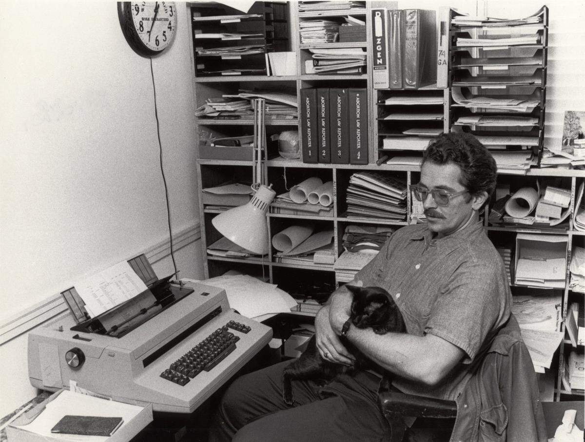 Tom Stickler, (with cat) pro-choice advocate in his office in February 1980. At the time of this photo, Stickler had been speaking out for abortion rights for the past 10 years. He helped start a local “Zero Population Growth” chapter and served on the board of directors of the Lexington Planned Parenthood.