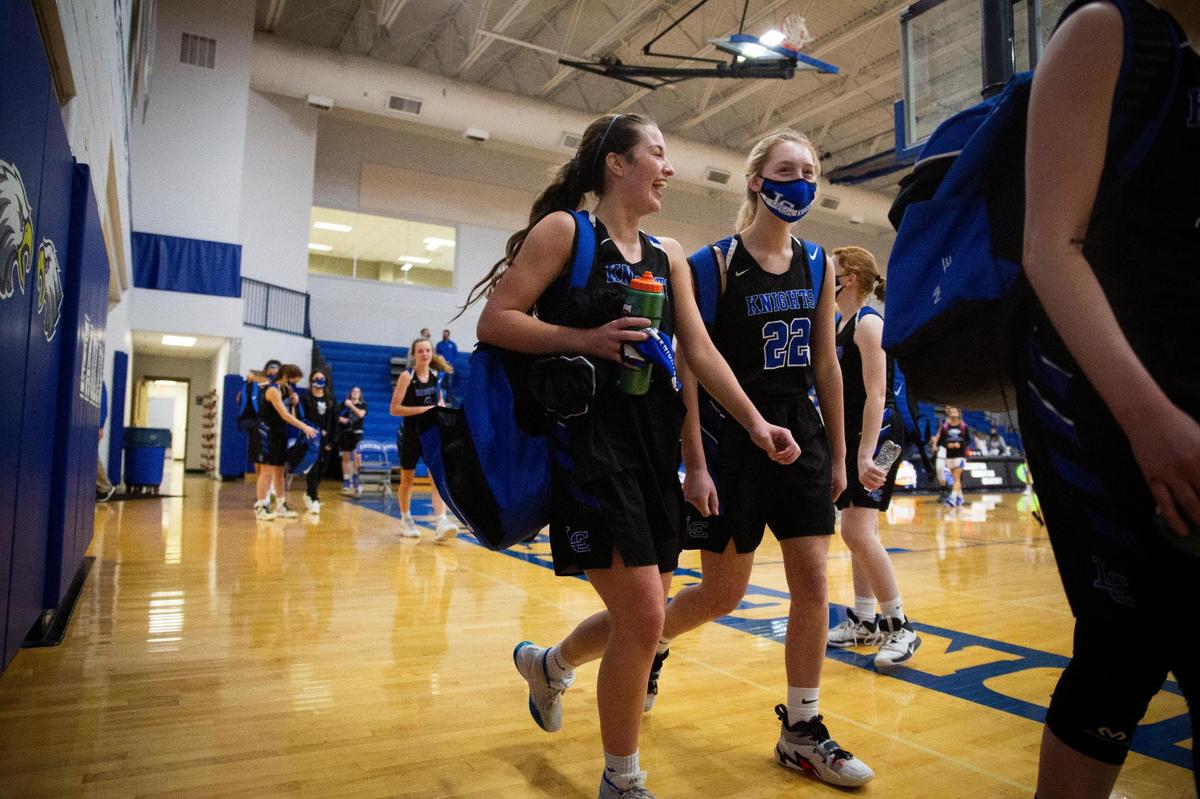 Lexington Catholic’s Hannah Carlisle (2) and Lucy Nash (22) laughed while walking out of the gym after their team’s win over Lexington Christian.