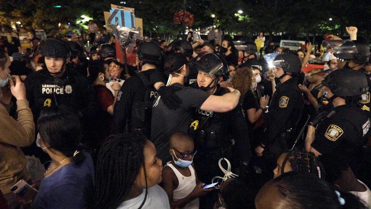 Protesters and police officers hugged and prayed together Monday during the fourth night of protests against police violence in downtown Lexington. Marcus Dorsey, Lexington Herald-Leader