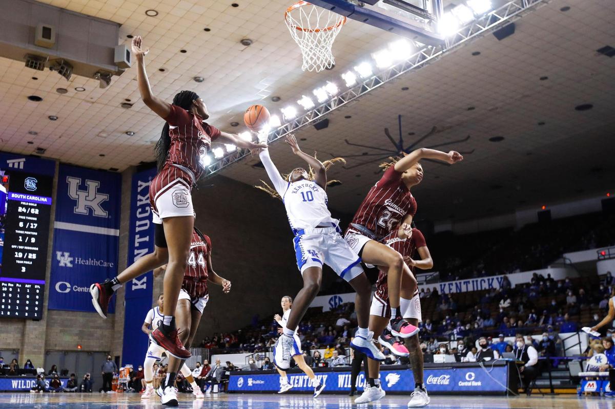 Kentucky’s Rhyne Howard (10) jumps to score and draw a foul while guarded by South Carolina’s LeLe Grissett (24) and Sania Feagin (20) at Memorial Coliseum on Feb. 10. Howard shoots 44.3% from the field, 34.2% from three-point range and 77.1% from the free-throw line.