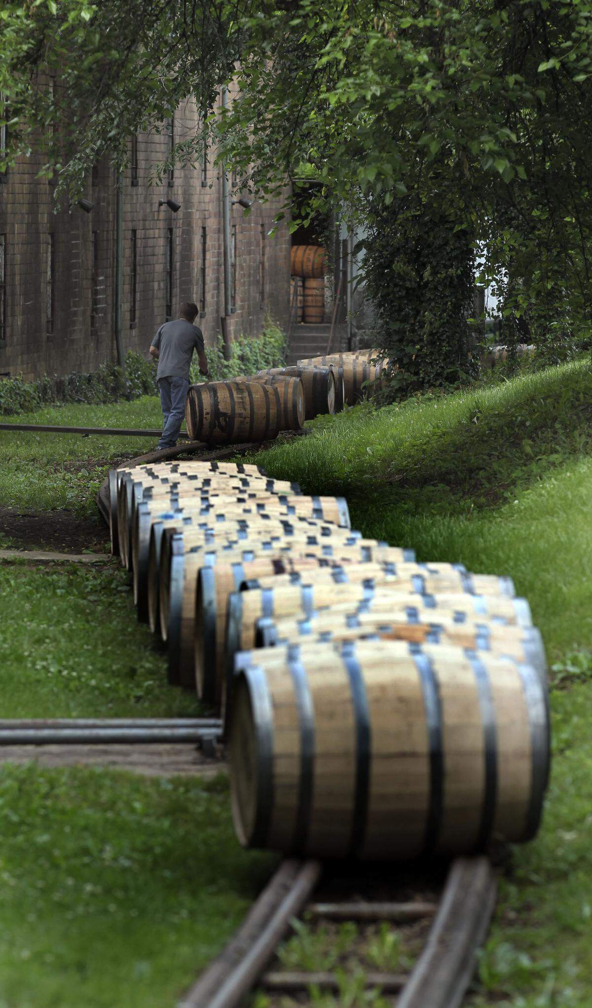 Freshly-filled barrels of Woodford Reserve are moved to a storage warehouse at the Woodford Reserve Distillery, 7855 McCracken Pike, near Versailles, Ky., Wednesday, June 05, 2013. Photo by Charles Bertram | Staff