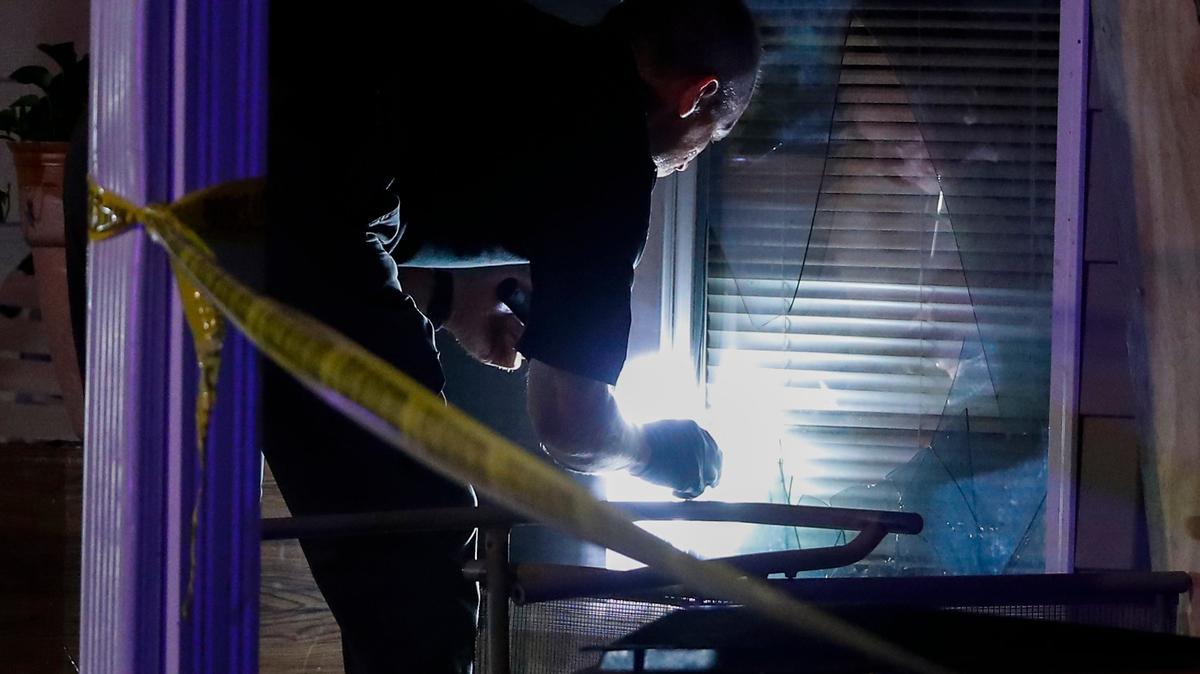 A Lexington police officer investigated a broken window at the scene of a shooting near the intersection of East Sixth Street and Chestnut Street in Lexington Thursday. Two people were transported from the scene by ambulance.