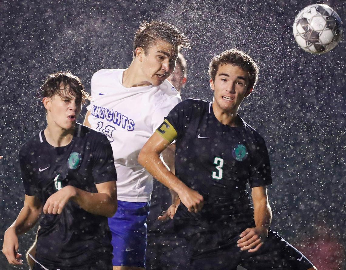 Lexington Catholic’s Justin Gal (18) headers the ball past Great Crossing’s Paul Redmon (4) and Great Crossing’s Reagan Disney (3) during the 11th Region semifinal at Lexington Christian in Lexington, Ky., Wednesday, Oct. 13, 2021. Lexington Catholic beat Great Crossing 7-0.