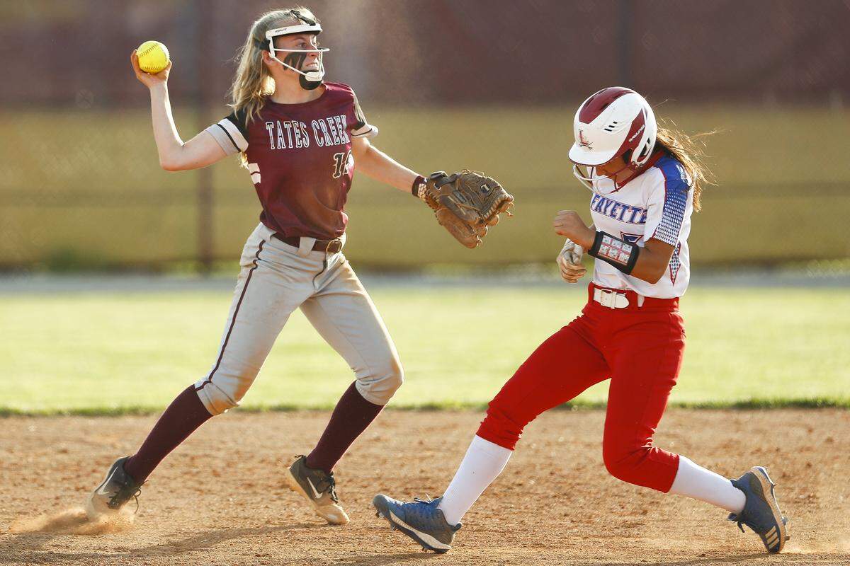 Tates Creek’s Sophie Kluesner (19) threw to first after forcing out Lafayette’s Isabelle Rochemont (5) at second during their game last season.